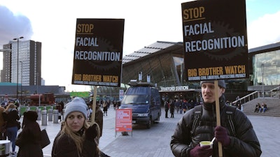 Demonstrates in front of a mobile police facial recognition facility outside a shopping centre in London.