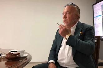 Venezuelan shipping magnate Wilmer Ruperti smokes a cigarette during an interview.