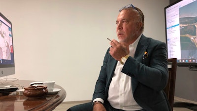 Venezuelan shipping magnate Wilmer Ruperti smokes a cigarette during an interview.