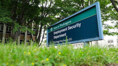 In this May 26, 2020, file photo, is a sign at the headquarters for Washington state's Employment Security Department at the Capitol in Olympia, Wash. Washington officials say they believe they have recovered about half of the up to $650 million in unemployment benefits paid to criminals who used stolen identities to file claims during the coronavirus pandemic.
