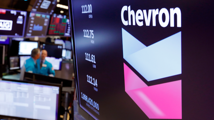 Chevron logo appears above a trading post on the floor of the New York Stock Exchange.