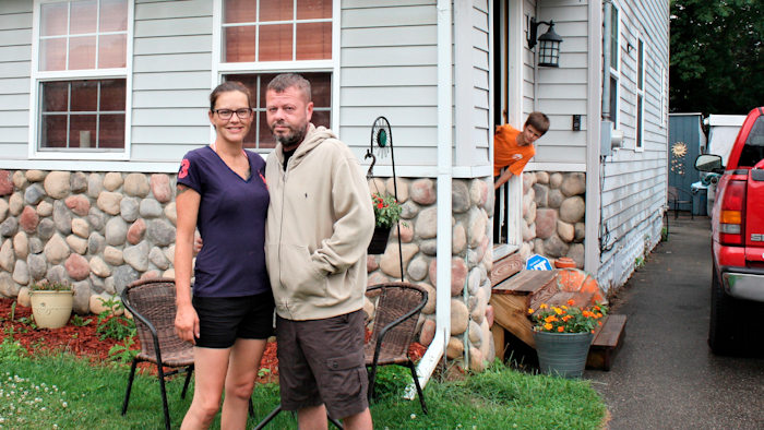 Crystal and Chris Martin stand outside their home, Sunday, July 19, 2020 in Burton, Mich.