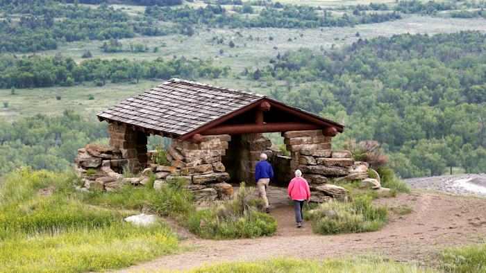 Visitors hike to a stone lookout over the Little Missouri River inside the Theodore Roosevelt National Park.
