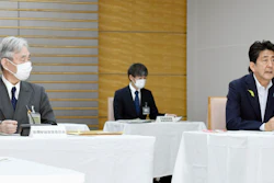 Japanese Prime Minister Shinzo Abe, right, at a government meeting on space development at his office in Tokyo, June 29, 2020.