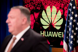 A monitor displays the logo for 'Huawei' behind Secretary of State Mike Pompeo.