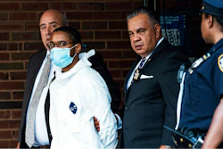 Tyrese Haspil, 21, is escorted out of the 7th precinct by NYPD detectives.