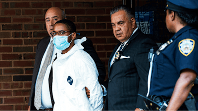 Tyrese Haspil, 21, is escorted out of the 7th precinct by NYPD detectives.