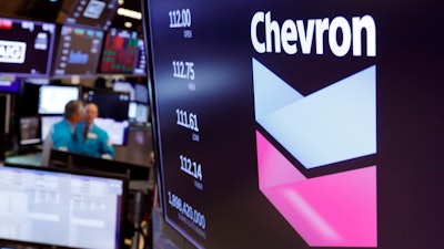 Chevron logo appears above a trading post on the floor of the New York Stock Exchange.