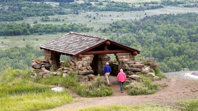 Visitors hike to a stone lookout over the Little Missouri River inside the Theodore Roosevelt National Park.