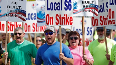 Striking Bath Iron Works shipbuilders march in solidarity.