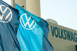 Flags wave in front of a factory building during the production restart of a VW plant in Zwickau, Germany.