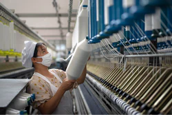 A woman works in a textile factory in Hai'an in eastern China's Jiangsu Province.