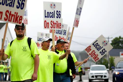 Picketers acknowledge a honking motorist outside an entrance to Bath Iron Works, Monday, June 22, 2020, in Bath, Maine. Production workers at one of the Navy's largest shipbuilders overwhelmingly voted to strike, rejecting the company's three-year contract offer Sunday and threatening to further delay delivery of ships.