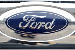 In this Oct. 20, 2019 file photograph, the company logo shines off the grille of an unsold 2019 F-250 pickup truck at a Ford dealership in Littleton, Colo. Ford Motor Co. reports quarterly financial results after the market close, Thursday, July 30 2020.
