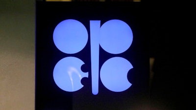 In this Thursday, Dec. 5, 2019, file photo, the advertising label of the Organization of the Petroleum Exporting Countries, OPEC, shines at their headquarters in Vienna, Austria. Ministers from the OPEC cartel have agreed to allow more oil to flow from the taps, saying demand for oil is growing as economies take steps to re-open. But they also cautioned that they could revisit the decision in an emergency meeting if there are serious lockdowns that further reduce demand for oil.