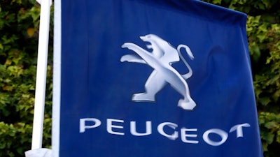 In this file photo dated Wednesday, Dec.18, 2019, the logo of French car maker Peugeot is pictured in Paris. The maker of Peugeot and Citroen cars, PSA Group, said Tuesday July 28, 2020, that it made a profit in the first six months of the year even as the coronavirus pandemic caused a deep drop in sales.