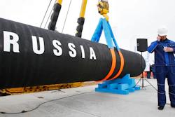 In this April 9, 2010 file photo, a Russian construction worker speaks on a mobile phone in Portovaya Bay some 170 kms (106 miles) north-west from St. Petersburg, Russia, during a ceremony marking the start of Nord Stream pipeline construction.