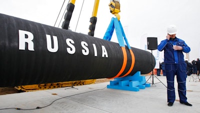 In this April 9, 2010 file photo, a Russian construction worker speaks on a mobile phone in Portovaya Bay some 170 kms (106 miles) north-west from St. Petersburg, Russia, during a ceremony marking the start of Nord Stream pipeline construction.