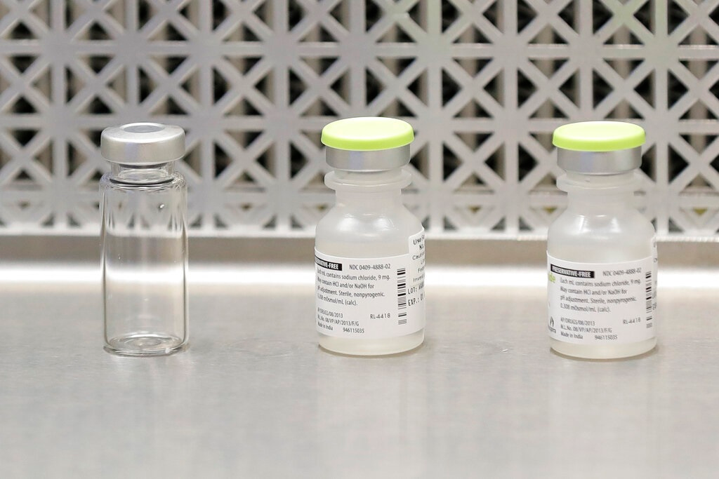 This March 16, 2020 file photo shows vials used by pharmacists to prepare syringes used on the first day of a first-stage safety study clinical trial of the potential vaccine for COVID-19, the disease caused by the new coronavirus, at the Kaiser Permanente Washington Health Research Institute in Seattle. The world's biggest COVID-19 vaccine test got underway Monday, July 27 with the first of 30,000 planned volunteers. The experimental vaccine is made by the National Institutes of Health and Moderna Inc., and it's one of several candidates in the final stretch of the global vaccine race.