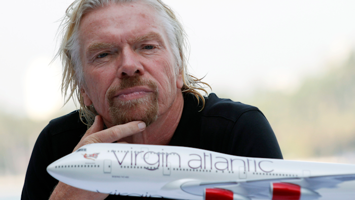 Richard Branson attends a news conference.
