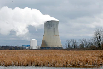 In this April 4, 2017, file photo, plumes of steam drift from the cooling tower of FirstEnergy Corp.'s Davis-Besse Nuclear Power Station in Oak Harbor, Ohio.