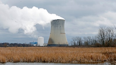 In this April 4, 2017, file photo, plumes of steam drift from the cooling tower of FirstEnergy Corp.'s Davis-Besse Nuclear Power Station in Oak Harbor, Ohio.