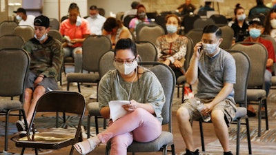 People wait to speak with representatives from the Oklahoma Employment Security Commission about unemployment claims on July 9 in Midwest City, OK.