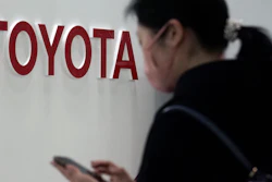 A visitor stands by the logo of Toyota Motor Corp. at its showroom in Tokyo.