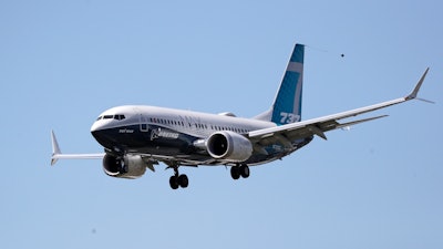 A Boeing 737 MAX jet heads to a landing at Boeing Field following a test flight.