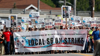 Striking Bath Iron Works shipbuilders march in solidarity.