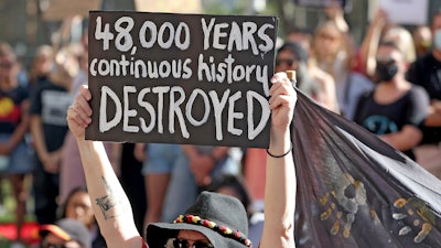 Protesters rally outside the Rio Tinto office in Perth, Australia.