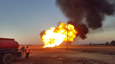 In this photo released by the Syrian official news agency, flames rise from a gas pipeline hit by an explosion between the northeastern Damascus suburbs of Adra and Dumair, Aug. 24, 2020.