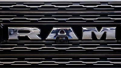 The Ram logo on the front grill of a Ram 1500.