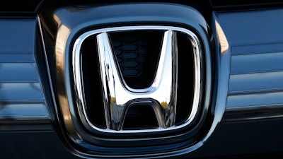 In this Jan. 11, 2016, file photo, the logo of Honda Motor Co. is seen on a Honda vehicle at the Japanese automaker's headquarters in Tokyo. Honda, on Tuesday, Aug. 4, 2020, is recalling over 1.6 million minivans and SUVs in the U.S. to fix problems that include faulty backup camera displays, malfunctioning dashboard lights and sliding doors that don’t latch properly. They cover certain Odyssey minivans from 2018 to 2020, Pilot SUVs from 2019 through 2021 and Passport SUVs from 2019 and 2020.