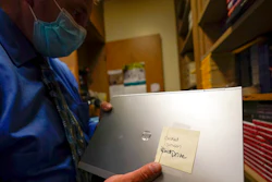 Tom Baumgarten, superintendent of the Morongo Unified School District, looks at a laptop with a cracked screen at Twentynine Palms Junior High School, Tuesday, Aug. 18, 2020, in Twentynine Palms, Calif. Baumgarten was set to order 5,000 Lenovo Chromebooks in July when his vendor called him off, saying Lenovos were getting 'stopped by a government agency because of a component from China that's not allowed here,' he said.