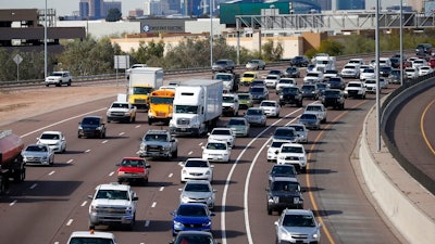 In this Jan. 24, 2020 file photo, early rush hour traffic rolls along I-10 in Phoenix. The U.S. government’s road safety agency is offering a smartphone app that will alert drivers if their vehicles are recalled. The National Highway Traffic Safety Administration was to roll out the app for Android and Apple phones on Thursday, Aug. 27.