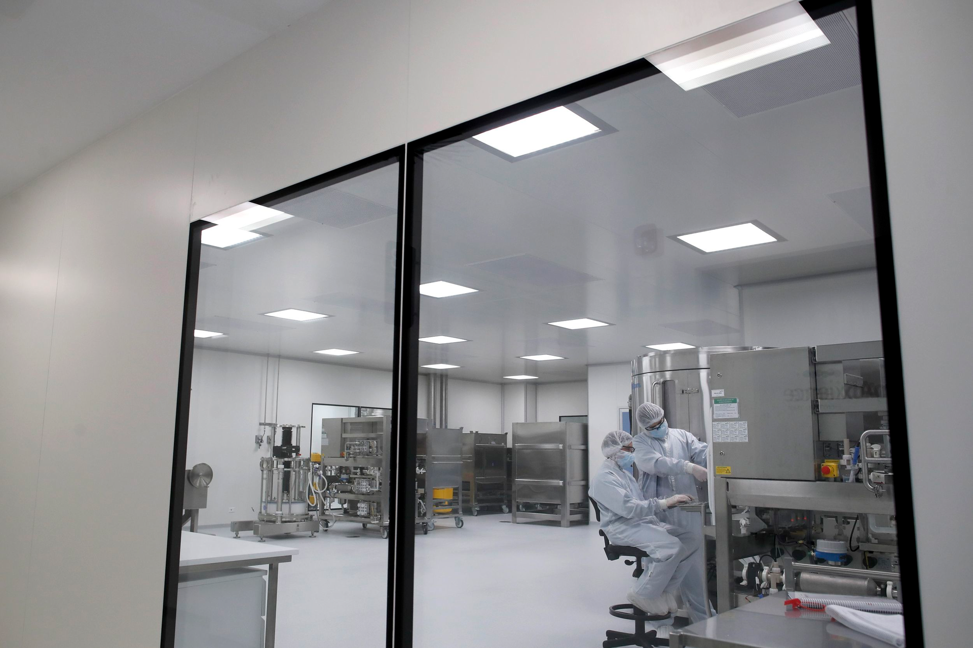 Laboratory technicians work at the mAbxience biopharmaceutical company on an experimental coronavirus vaccine developed by Oxford University and AstraZeneca, Garin, Argentina, Aug. 14, 2020.