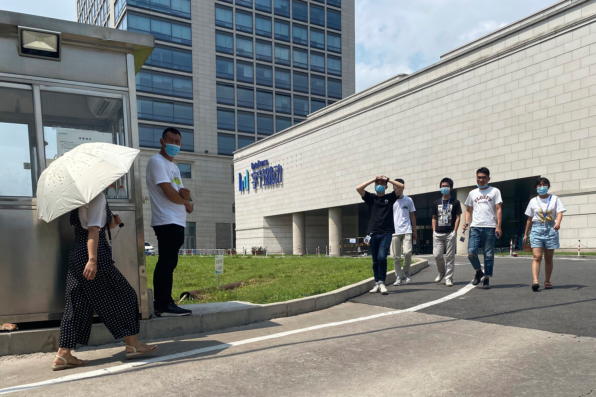 Employees exit the ByteDance headquarters in Beijing, Aug. 7, 2020.