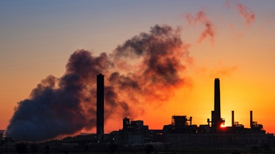 The Dave Johnson coal-fired power plant is silhouetted against the morning sun in Glenrock, Wyo.