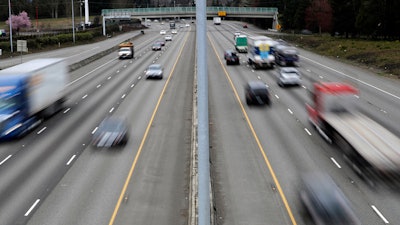 Cars and trucks travel on Interstate 5 near Olympia, Wash.