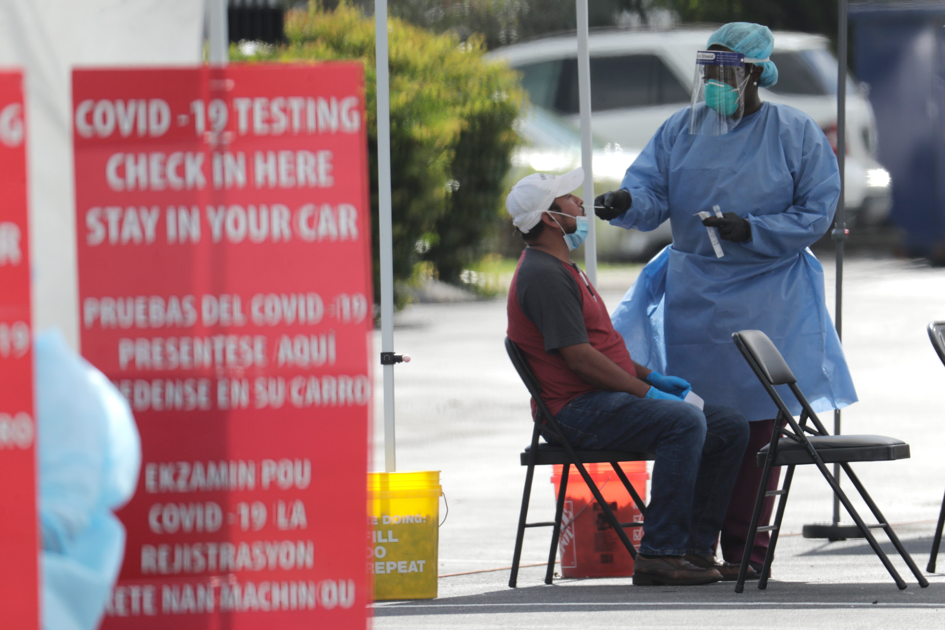 A health care worker administers a COVID-19 test at the Martin Luther King, Jr. Clinica Campesina Health Center in Homestead, Fla., July 6, 2020.