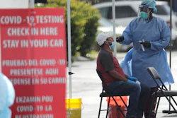 A health care worker administers a COVID-19 test at the Martin Luther King, Jr. Clinica Campesina Health Center in Homestead, Fla., July 6, 2020.