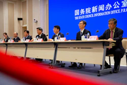 Chinese health officials attend a press conference held to discuss COVID-19 vaccine-related issue.