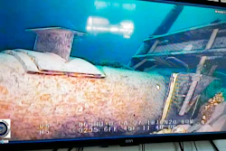 Shot from a television screen shows damage to anchor support EP-17-1 on the east leg of the Enbridge Line 5 pipeline within the Straits of Mackinac in Michigan.