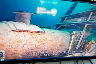 Shot from a television screen shows damage to anchor support EP-17-1 on the east leg of the Enbridge Line 5 pipeline within the Straits of Mackinac in Michigan.