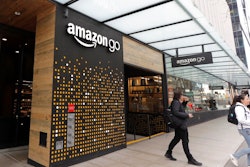 In this March 4, 2020 file photo, people walk out of an Amazon Go store, in Seattle. Amazon is rolling out a new device for contactless transactions that will scan an individual’s palm. The Amazon One, which will initially launch in two Amazon Go stores in Seattle, is being viewed as a way for people to use their palm to make everyday activities like paying at a store easier.