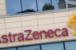 This Saturday, July 18, 2020 file photo shows a general view of AstraZeneca offices and the corporate logo in Cambridge, England. Late stage trials into a coronavirus vaccine developed by Oxford University and drugmaker AstraZeneca were paused after a woman who received the experimental shot developed severe neurological symptoms, a spokesman for the pharmaceutical said Thursday, Sept. 10, 2020.
