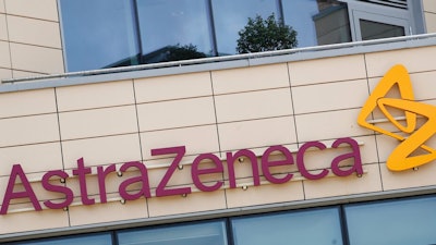 This Saturday, July 18, 2020 file photo shows a general view of AstraZeneca offices and the corporate logo in Cambridge, England. Late stage trials into a coronavirus vaccine developed by Oxford University and drugmaker AstraZeneca were paused after a woman who received the experimental shot developed severe neurological symptoms, a spokesman for the pharmaceutical said Thursday, Sept. 10, 2020.