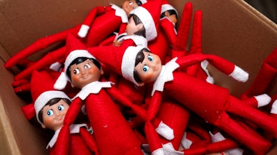 Elf on the Shelf figures are piled in a box at the company's studio Thursday, Aug. 27, 2020, in Atlanta. Thousands of suppliers routinely rely on credit insurance to cover potential losses if any of the retailers they work with can’t pay for the goods they’ve ordered. But now insurers are scaling back on coverage because they are unwilling to take a chance on retailers that are struggling to survive during the pandemic. Christa Pitts, founder and co-CEO of The Lumistella Company, which produces toys, books and other products under the Elf on the Shelf and Elf Pets brands, says her retail orders were covered 100% before the pandemic. Now, only 50% are covered, forcing her to rethink who she will sell to.