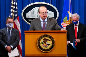 Jeff Clark, Assistant Attorney General for the Environment and Natural Resources Division, speaks as Deputy Attorney General Jeffrey Rosen, right, and Environmental Protection Agency (EPA) Administrator Andrew Wheeler, left, look on during a news conference at the Justice Department in Washington, Monday, Sept. 14, 2020. Automakers Daimler AG and subsidiary Mercedes-Benz USA have agreed to pay $1.5 billion to the U.S. government and California state regulators to resolve emissions cheating allegations.